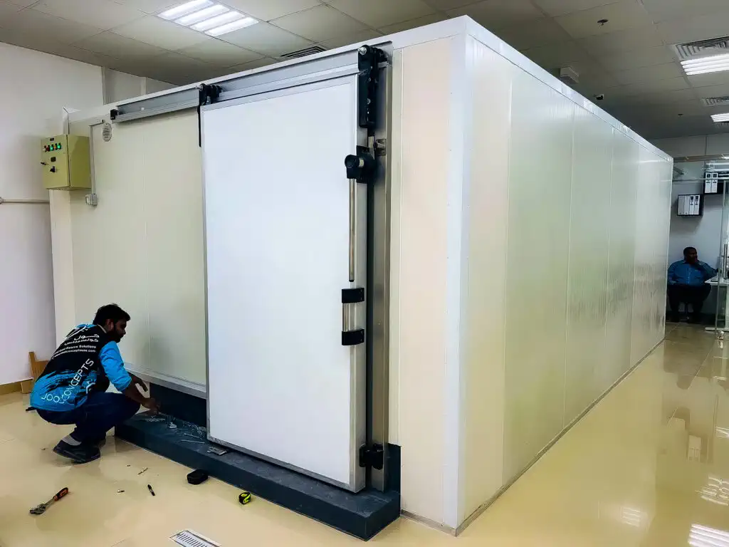 Technician performing maintenance on a commercial cold room in Cape Town