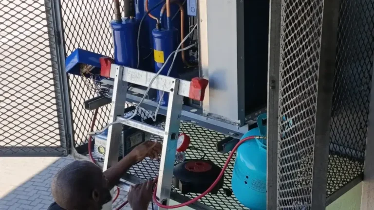 Technician repairing cold-room refrigeration equipment