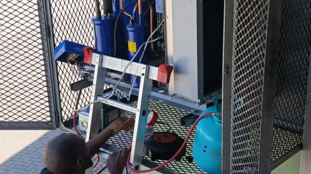 Technician repairing cold-room refrigeration equipment